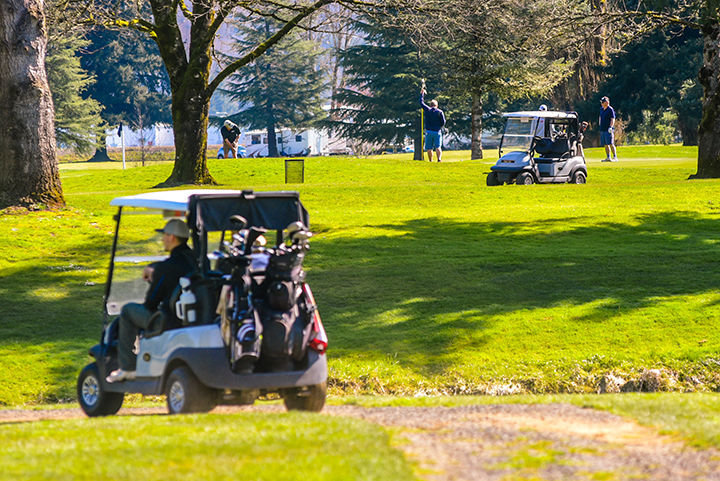 FILE PHOTO - Carts and golfers line the grass as Riverside Golf Course in March 2020.